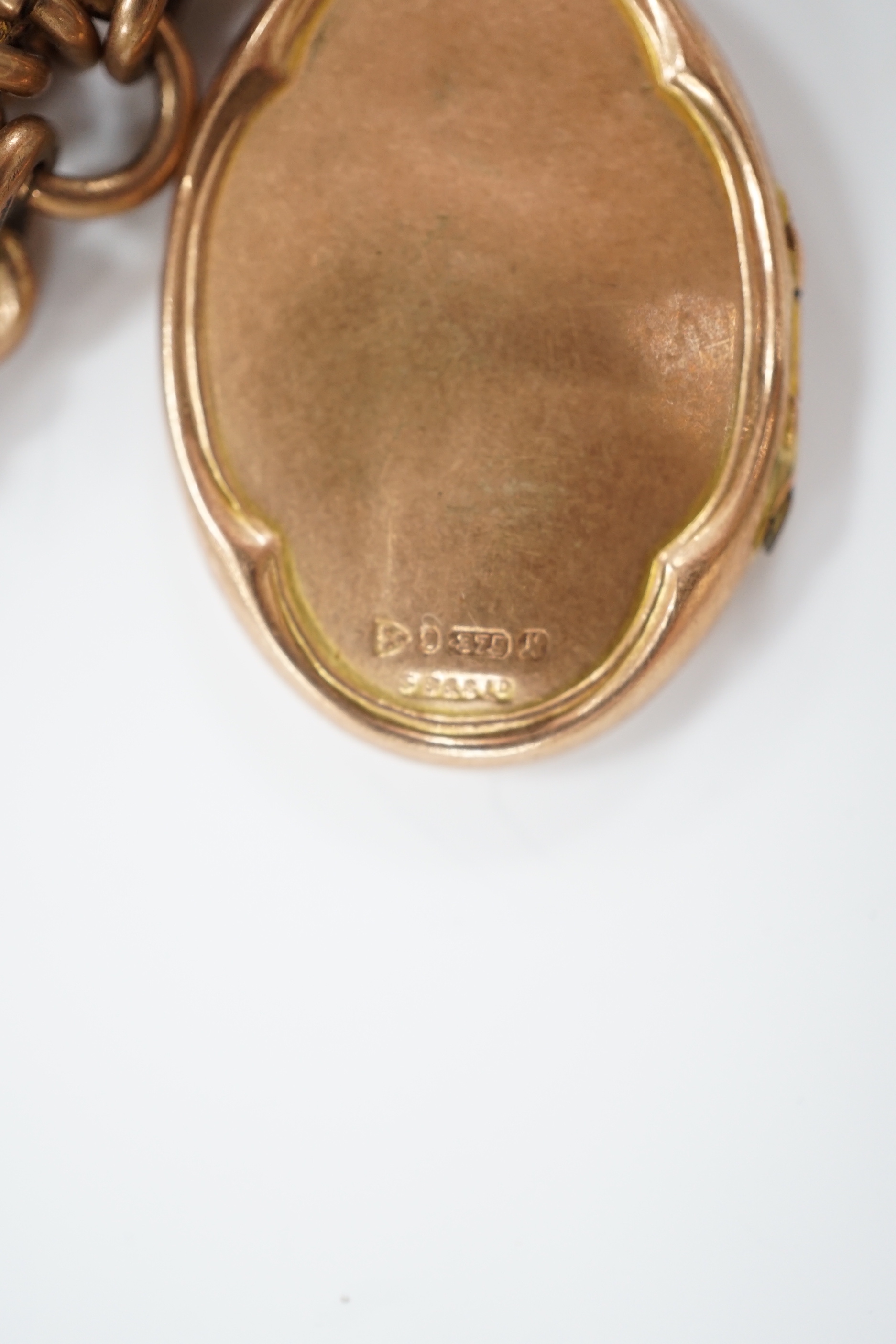 An Edwardian 9ct gold graduated curb link albert, 35cm, hung with a 9ct gold locket, gross 48.6 grams.